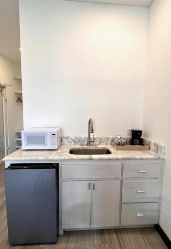 a kitchen with a sink and a microwave at The Watermark Hotel in San Pedro