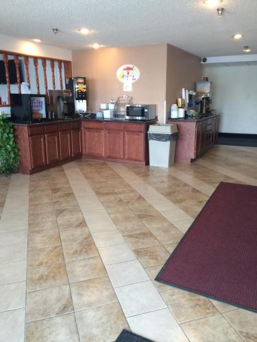 a large room with a food counter in a restaurant at Super 8 by Wyndham Winnemucca NV in Winnemucca