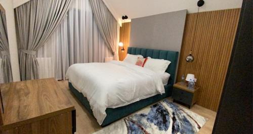 a bedroom with a large white bed and a table at Duplex in four seasons new gudauri near gondola in Gudauri
