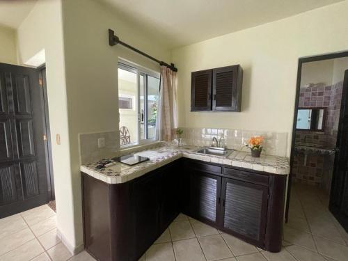 a large bathroom with a sink and a mirror at Hotel Castillo Del Mar - 5 Th Ave in Playa del Carmen