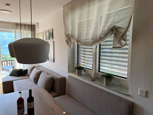 a living room with a couch and a window at Apartment Deluxe Ossiacher See - Gerlitzen in Sattendorf