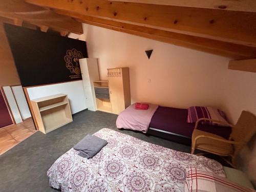 a bedroom with two beds in a room at Gite la Cigale lit en dortoir in Saxon