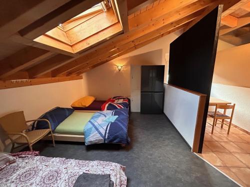 a dorm room with a bed and a table at Gite la Cigale lit en dortoir in Saxon