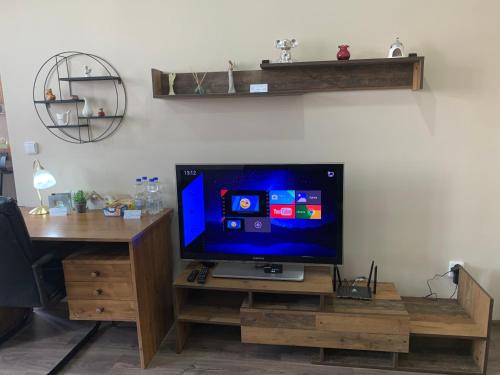 a flat screen tv sitting on a wooden stand at Kael Apartman 02 in Teplice