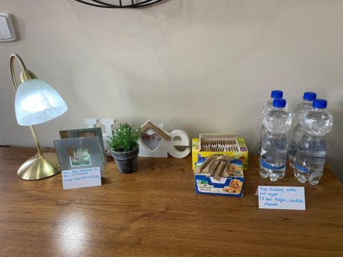 a desk with two bottles of water and a lamp at Kael Apartman 02 in Teplice