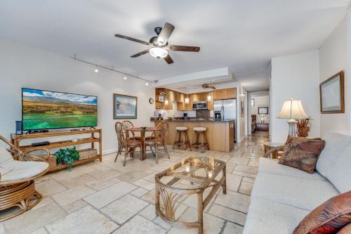 a living room with a couch and a tv at Papakea #F108 condo in Kahana