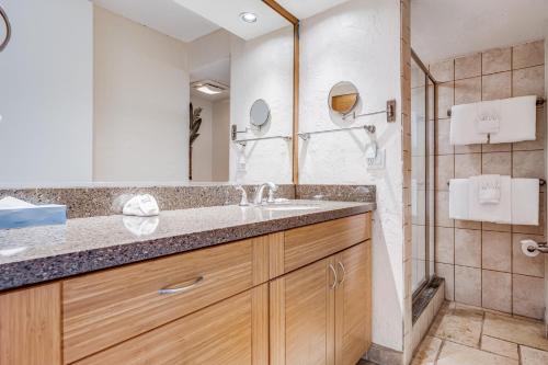 a bathroom with a sink and a shower at Papakea #F108 condo in Kahana