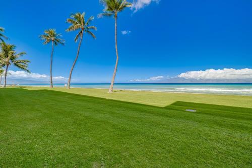 a golf course with palm trees on the beach at Papakea #F108 condo in Kahana