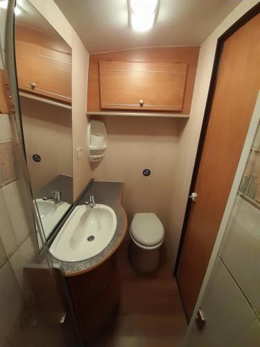 a small bathroom with a sink and a toilet at Kromven On Wheels in Merksplas
