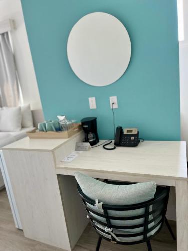 a desk with a chair in a room with a mirror at The Watermark Hotel in San Pedro