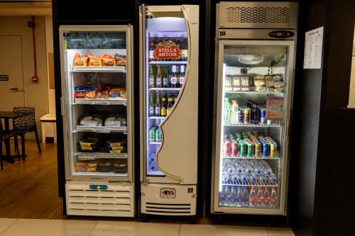 two refrigerators are standing next to each other at Nobile Inn Pampulha in Belo Horizonte