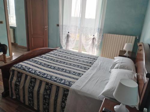 Una cama con edredón en un dormitorio en B&B I lupi, en Casa Furno