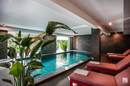 a swimming pool in the middle of a house at La Casa nel Parco luxury b&b in San Lazzaro di Savena