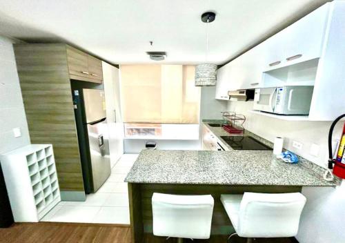 a kitchen with a counter and some white appliances at SUITE PARQUE LA CAROLINA in Quito
