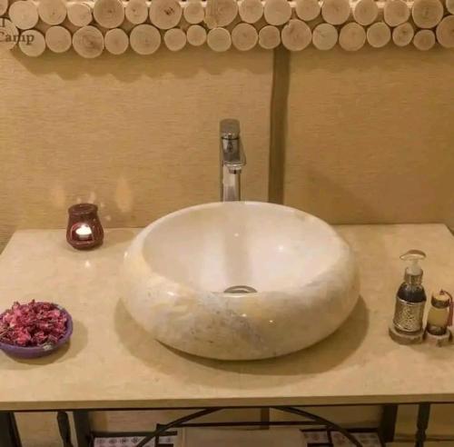 a bathroom sink with a white bowl on a counter at Maria Sahara Camp in Merzouga