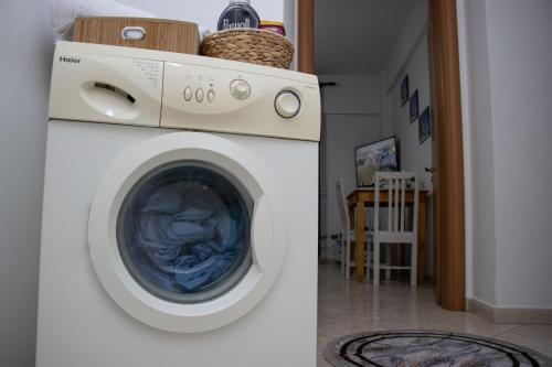 a white washing machine in a living room at Amazing Paradise Sensation 2 Bedroom Luxury Apartment with a Jacuzzi in Durrës