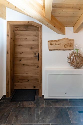 a room with a wooden door and a table at Haus Kogelleiten in Ramsau