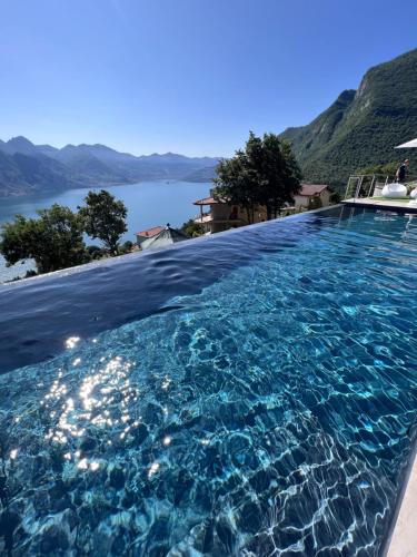 a swimming pool with a view of the water at Esprit D'Hotel Panoramico in Fonteno