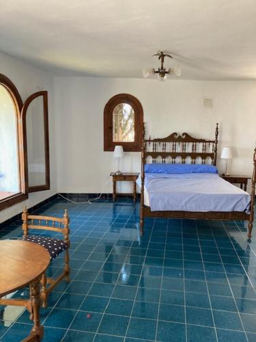 een slaapkamer met een bed en een blauwe tegelvloer bij House in Andalucia, SPAIN in Salobreña