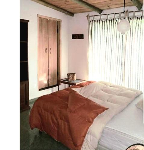a bedroom with a large bed and a table at El secreto in Ciudad de la Costa