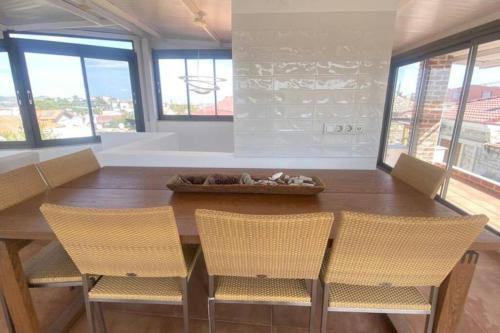 a dining room with a wooden table and chairs at Urla Casa Bianca in Urla