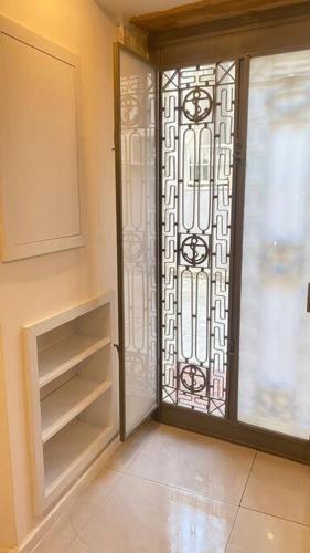 a room with a door and a glass door with shelves at Urla Casa Bianca in Urla