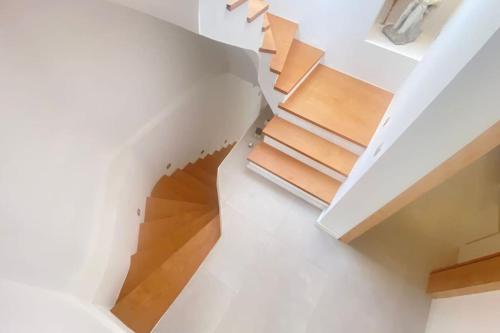 a spiral staircase in a house with books at Urla Casa Bianca in Urla
