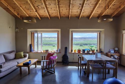 a living room with a couch and a table at Casa familiar Fellow - Casa de Bioconstrucción a 4 km de Trevelin in Trevelin