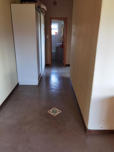 an empty hallway with a tile floor in a room at Casa familiar Fellow - Casa de Bioconstrucción a 4 km de Trevelin in Trevelin