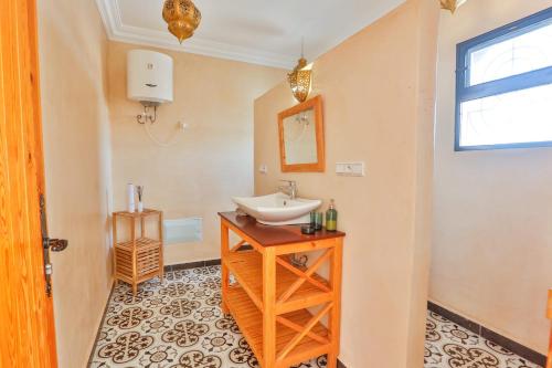 a bathroom with a sink and a mirror at Maison Insa in Essaouira