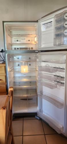 an empty refrigerator with its door open in a kitchen at Cerro Indio in Potrerillos