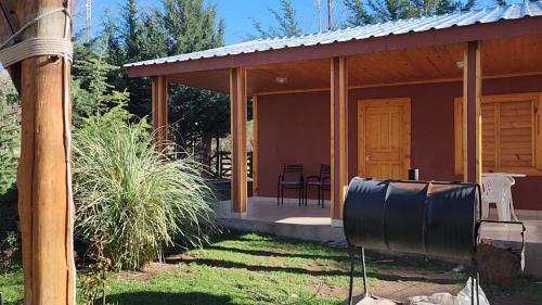 a house with a covered porch with a grill at Cerro Indio in Potrerillos