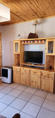 a large entertainment center with a television in a room at Cerro Indio in Potrerillos