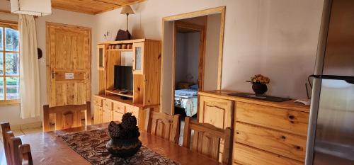 a living room with a table and a kitchen with a television at Cerro Indio in Potrerillos