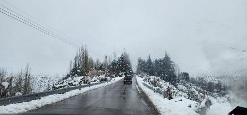 a car driving down a snow covered road at Cerro Indio in Potrerillos