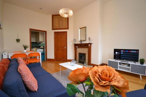 a living room with a blue couch and a fireplace at Central City Castle Apartment FREE parking Private in Nottingham