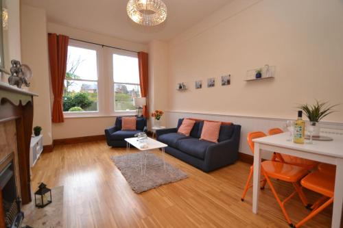a living room with a couch and a table at Central City Castle Apartment FREE parking Private in Nottingham