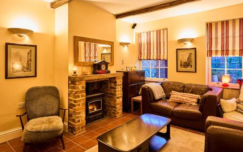 a living room with a couch and a fireplace at Nature Charm & Fruit Delights, multi-generation celebratory home -Try, Relax, Repeat - Sellindge in Ashford