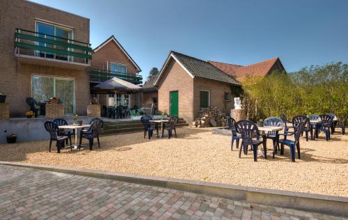 a group of tables and chairs in a courtyard at Hotel Eperland in Epen