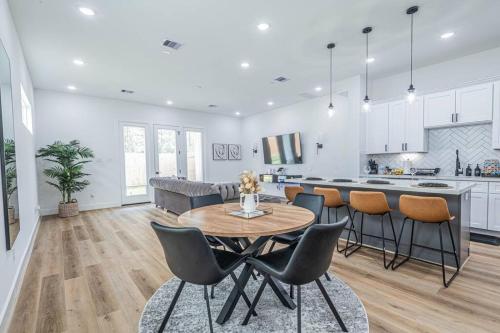 a kitchen and living room with a table and chairs at Luxury Home Near Houston Downtown & Medical Center in Houston