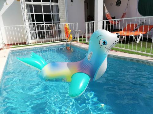 a inflatable mermaid pool noodle in a swimming pool at Marreiro's house Algarve - Child friendy - Private Pool in Lagos