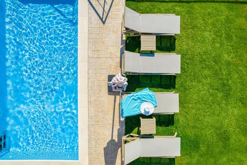 an overhead view of a swimming pool with a towel on a chair next to at Villa Lia Chania with private ecologic pool and amazing view! in Chania