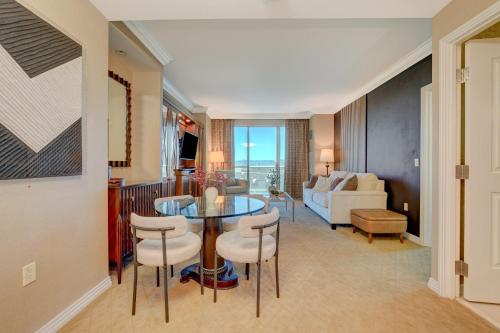 a living room with a table and chairs and a couch at LUXURIOUS 1 BD/2BTH Premium Suite MGM Signature w/balcony in Las Vegas