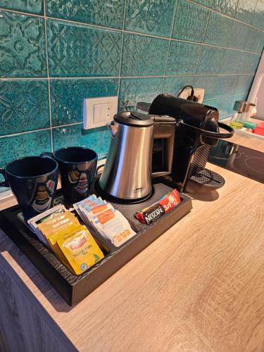 a tea kettle on a tray on a kitchen counter at Booking Apartment Rajiceva in Belgrade