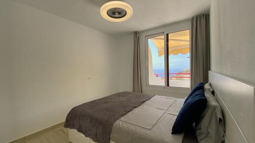 a bedroom with a bed and a window at Inagua Sol apartment in Puerto Rico de Gran Canaria