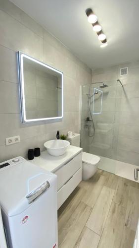 a bathroom with a sink and a toilet and a shower at Inagua Sol apartment in Puerto Rico de Gran Canaria