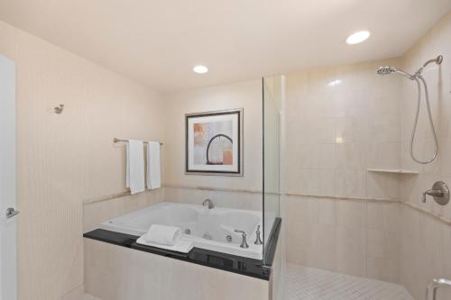 a bathroom with a bath tub and a shower at Lucky Gem Penthouse & Luxury Suites at Signature Resort, Balcony Strip View 1607 in Las Vegas