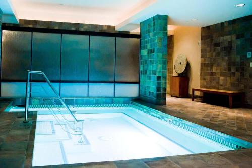 a swimming pool with a staircase in a building at Lucky Gem Penthouse & Luxury Suites at Signature Resort, Balcony Strip View 1607 in Las Vegas