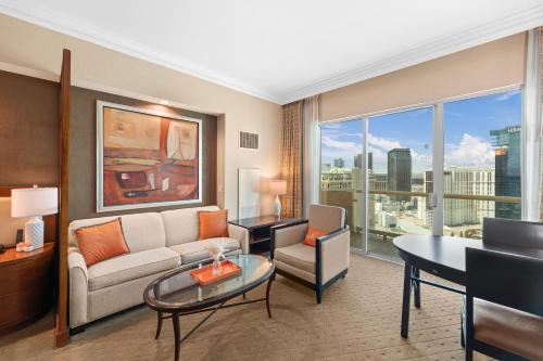 a living room with a couch and a table at Lucky Gem Penthouse & Luxury Suites at Signature Resort, Balcony Strip View 1607 in Las Vegas