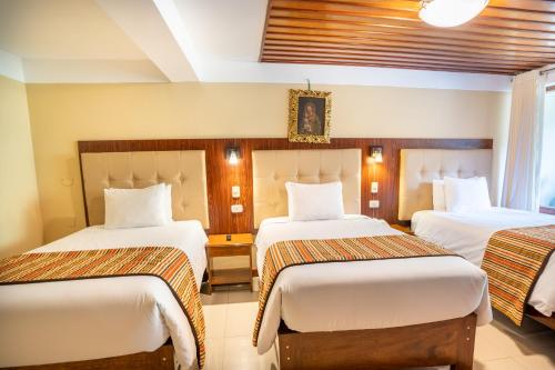 a hotel room with two beds in a room at Santuario Machupicchu in Machu Picchu